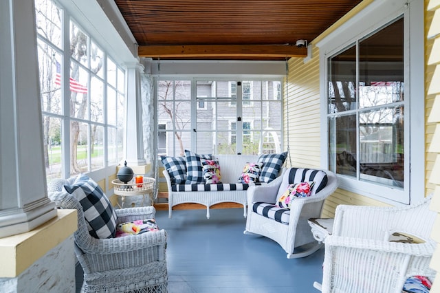 sunroom / solarium with wooden ceiling, a wealth of natural light, and beamed ceiling