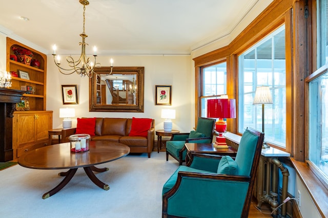 sitting room featuring a chandelier, crown molding, and carpet floors