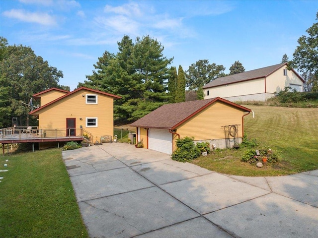 view of front of house with a garage, a wooden deck, and a front yard