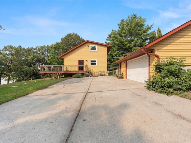 view of front of house with a wooden deck and a front lawn