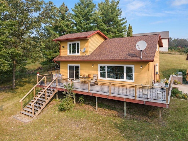 back of house featuring a deck and a yard