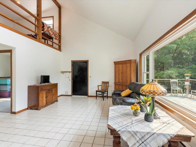 living room featuring high vaulted ceiling and light tile patterned floors