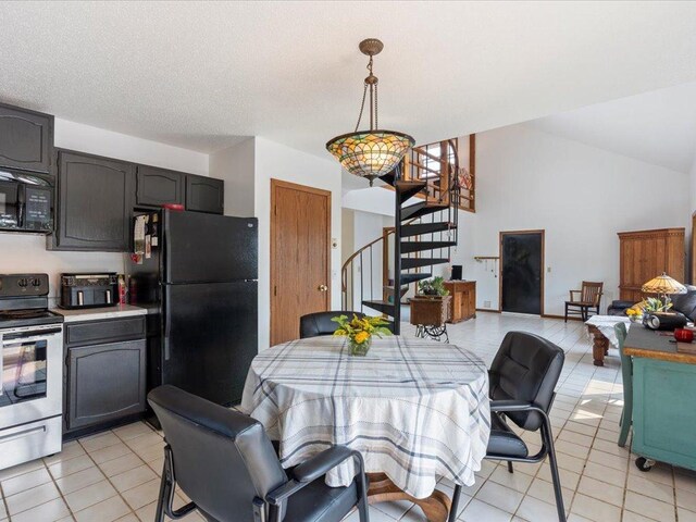 tiled dining area featuring a textured ceiling