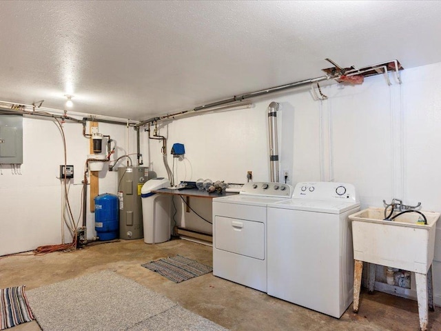 washroom with a textured ceiling, washing machine and dryer, electric panel, and electric water heater