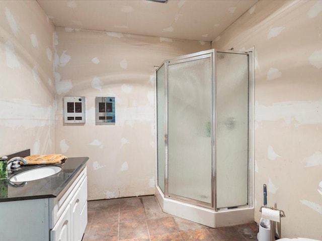 bathroom featuring vanity and a shower with shower door