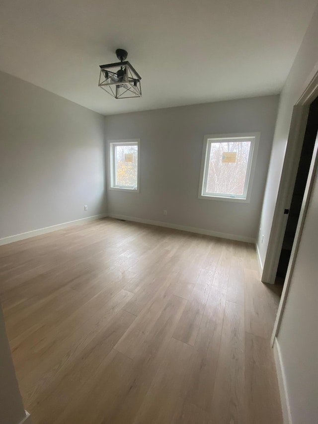 spare room featuring light hardwood / wood-style floors