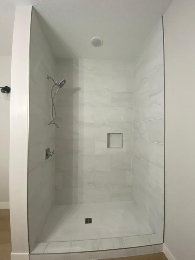 bathroom with a tile shower