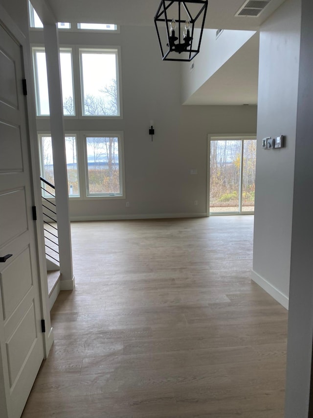 foyer featuring light hardwood / wood-style flooring and a chandelier