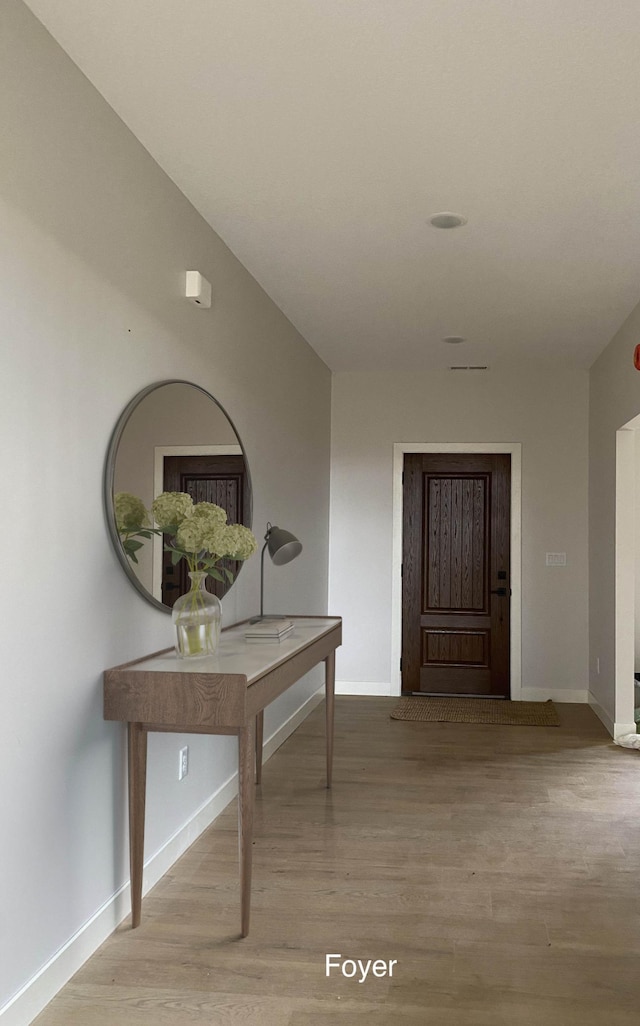 hallway with wood-type flooring