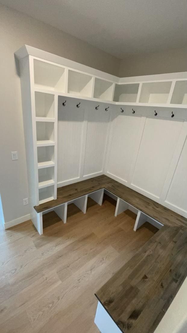 mudroom with light hardwood / wood-style floors