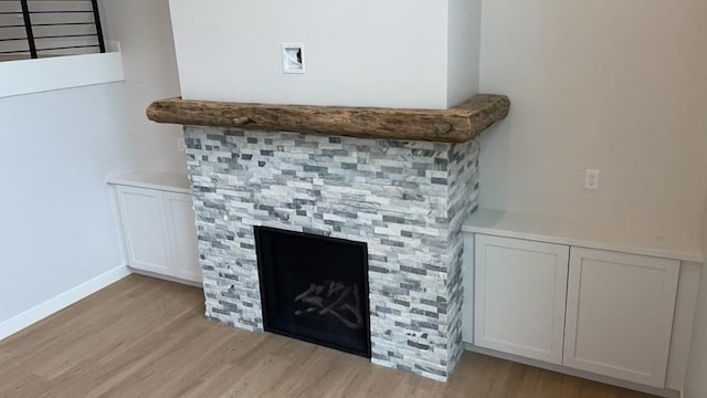 interior details featuring a fireplace and wood-type flooring