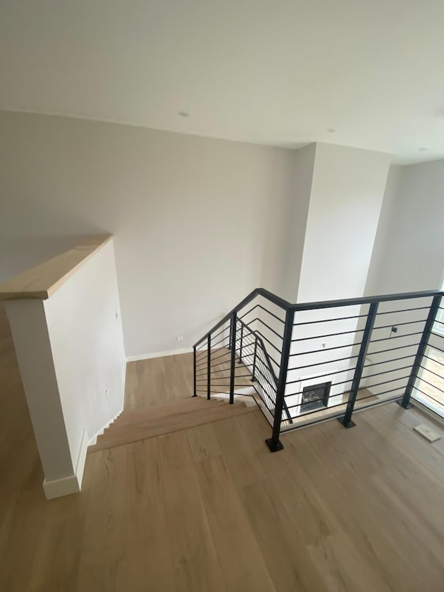 stairs with hardwood / wood-style flooring