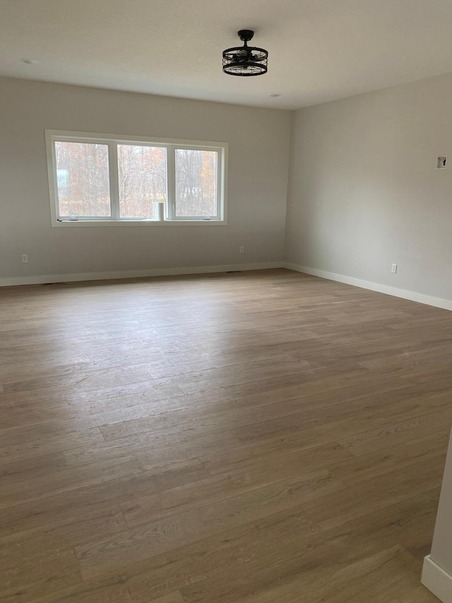 empty room featuring plenty of natural light and wood-type flooring