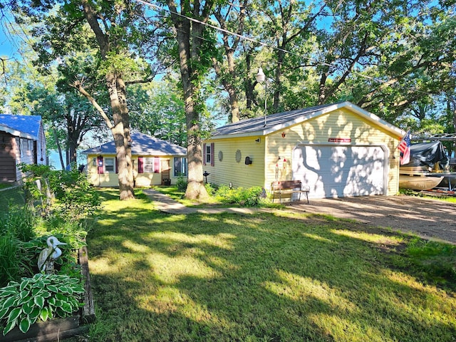 exterior space featuring a garage, an outdoor structure, and a lawn