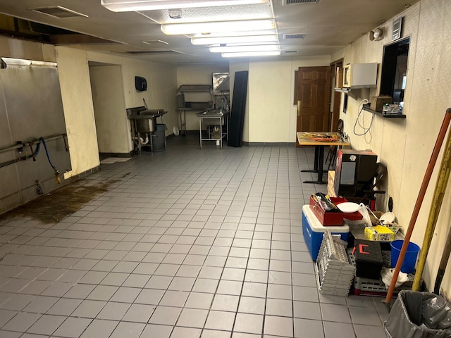 basement featuring light tile patterned floors