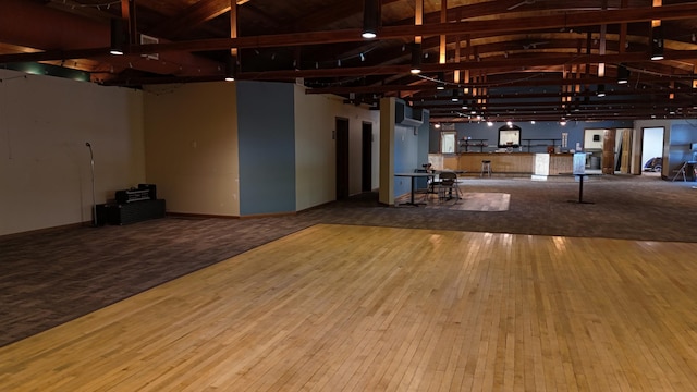 interior space with high vaulted ceiling, beam ceiling, and hardwood / wood-style flooring