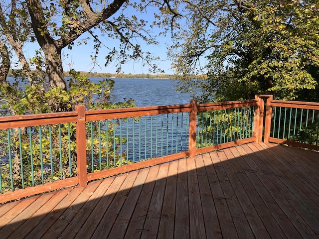 wooden deck featuring a water view