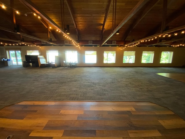 interior space featuring wood ceiling, beam ceiling, carpet, and high vaulted ceiling