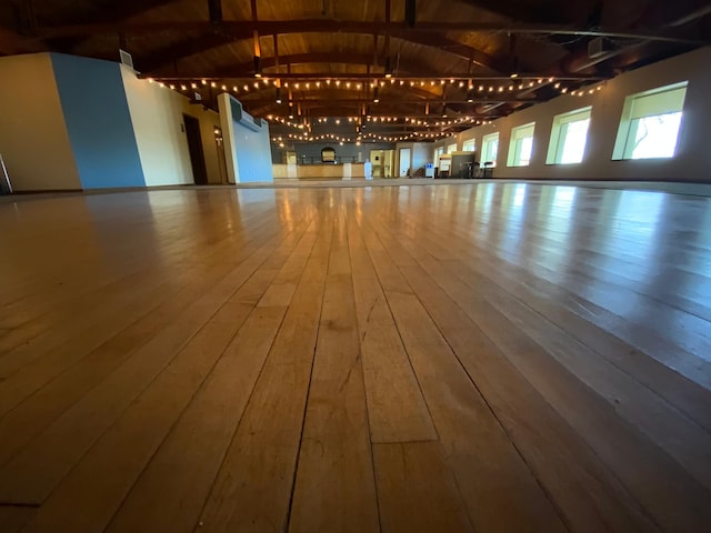 interior space featuring vaulted ceiling with beams and hardwood / wood-style floors