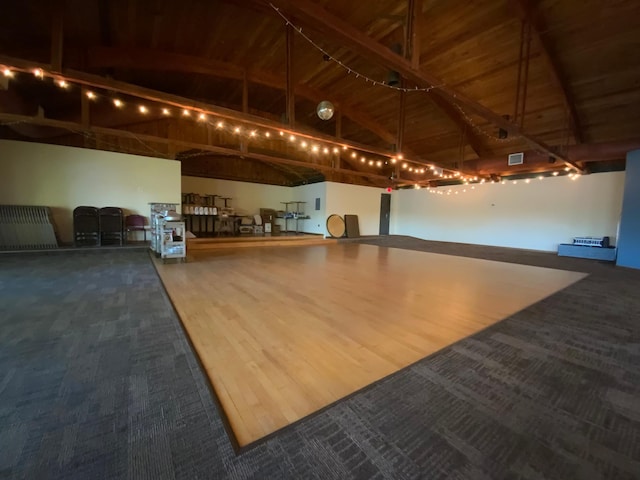 misc room featuring wood ceiling, beam ceiling, high vaulted ceiling, and hardwood / wood-style flooring