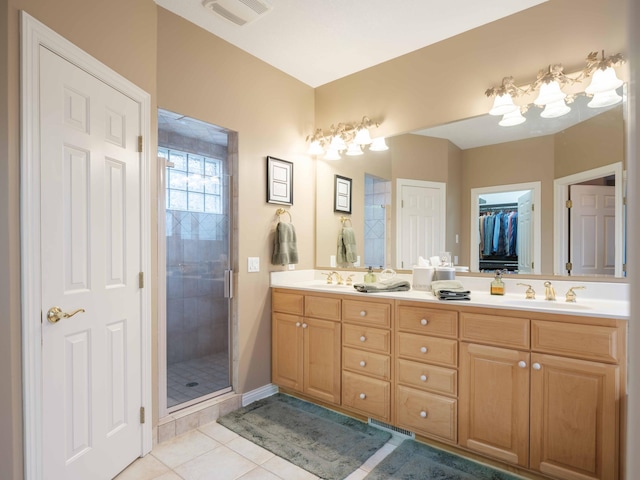 bathroom with tile patterned floors, vanity, and an enclosed shower