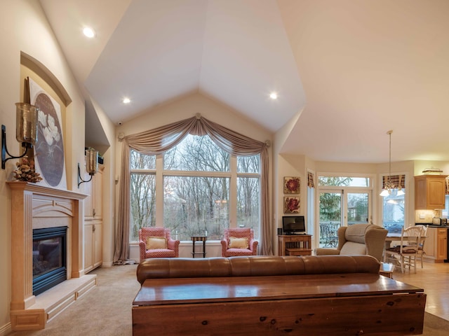 carpeted living room with vaulted ceiling and a wealth of natural light