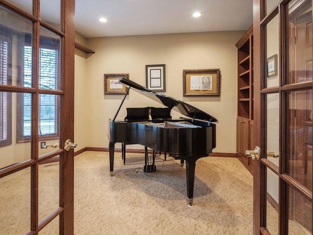 miscellaneous room featuring light carpet and french doors