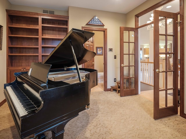 miscellaneous room featuring french doors and light colored carpet