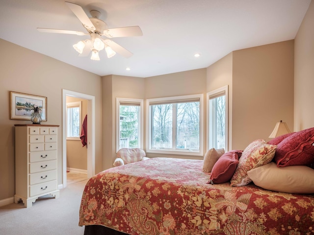 bedroom with ceiling fan and light colored carpet