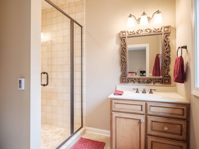 bathroom with tile patterned floors, vanity, and an enclosed shower