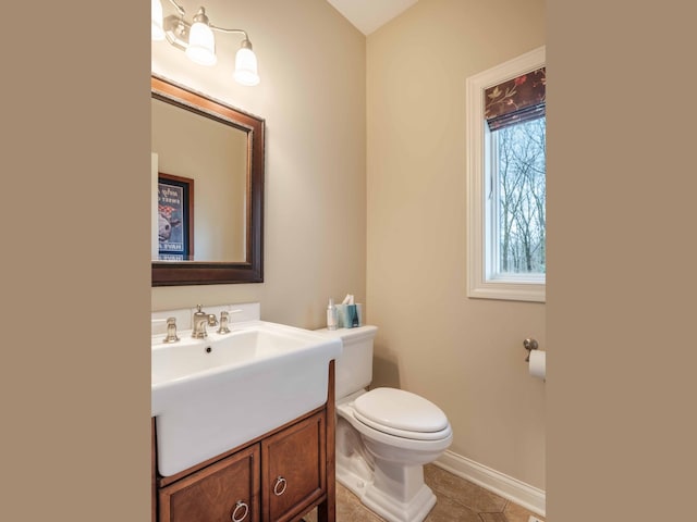 bathroom with tile patterned flooring, vanity, and toilet