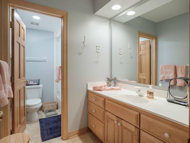 bathroom with tile patterned flooring, vanity, and toilet