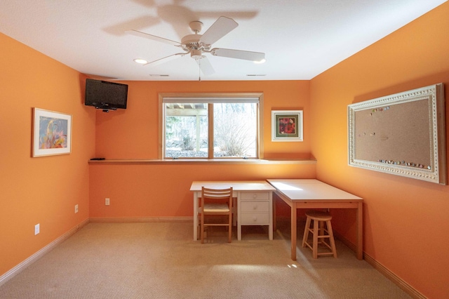 unfurnished office featuring ceiling fan and light carpet