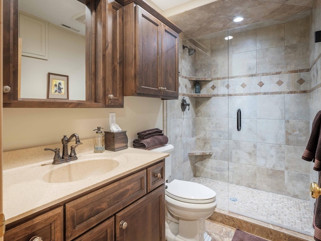 bathroom featuring vanity, toilet, and an enclosed shower