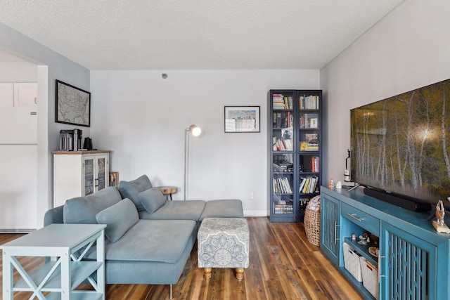 living room featuring a textured ceiling and dark wood-type flooring