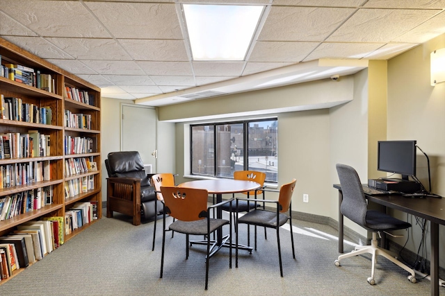 home office with a paneled ceiling and carpet