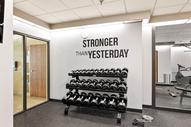 exercise room with a paneled ceiling