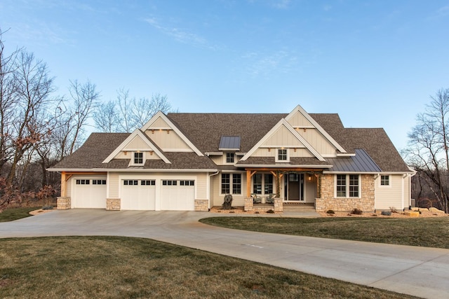 craftsman house featuring covered porch, a garage, and a front yard