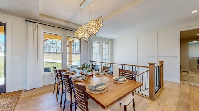 dining room with an inviting chandelier and light wood-type flooring