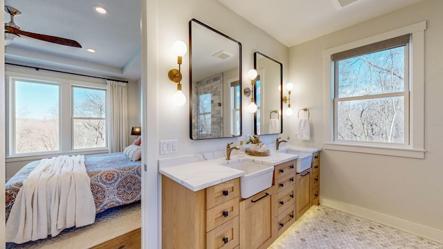 bathroom featuring vanity, ceiling fan, and a healthy amount of sunlight