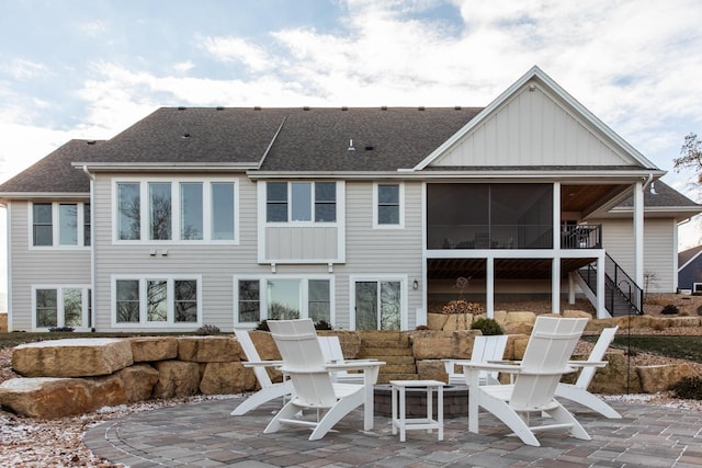 back of property with a sunroom and a patio