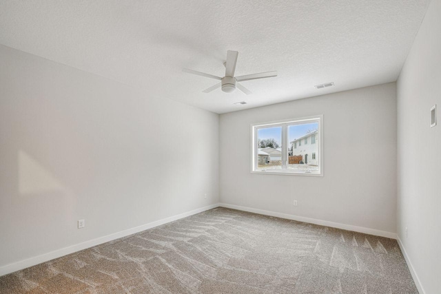 carpeted empty room featuring a textured ceiling and ceiling fan