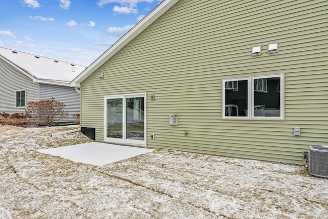 rear view of house featuring cooling unit and a patio