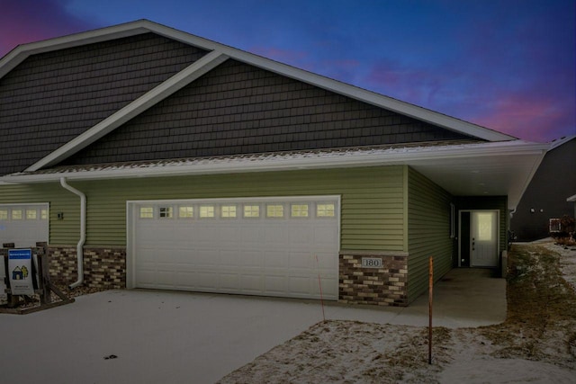 property exterior at dusk featuring a garage