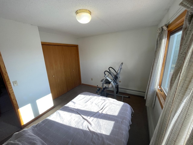 carpeted bedroom with a closet and a textured ceiling