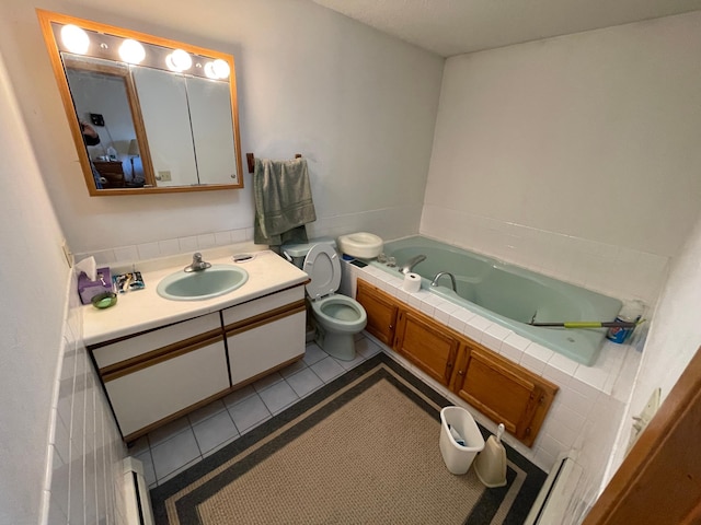 bathroom featuring tile patterned flooring, vanity, a bathtub, and toilet