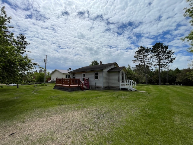 view of home's exterior featuring a yard and a wooden deck