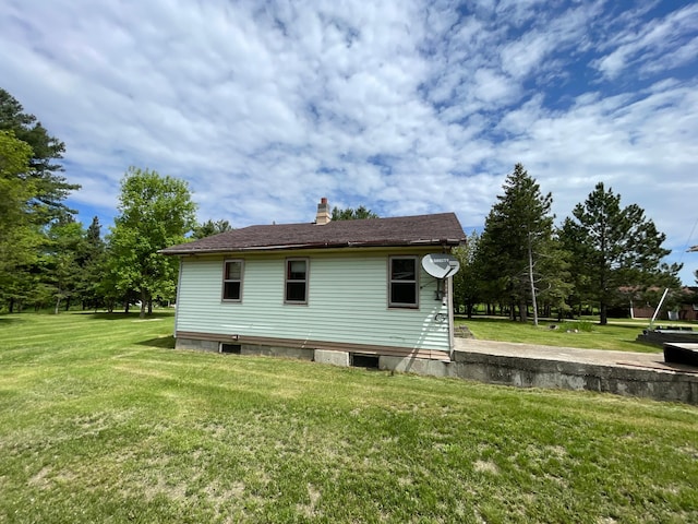 view of side of property with a lawn