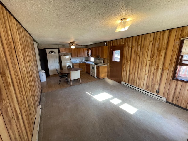 kitchen featuring white fridge, electric stove, a textured ceiling, and a baseboard radiator