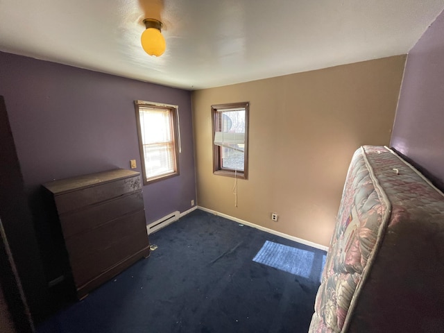 unfurnished bedroom featuring a baseboard radiator and dark carpet